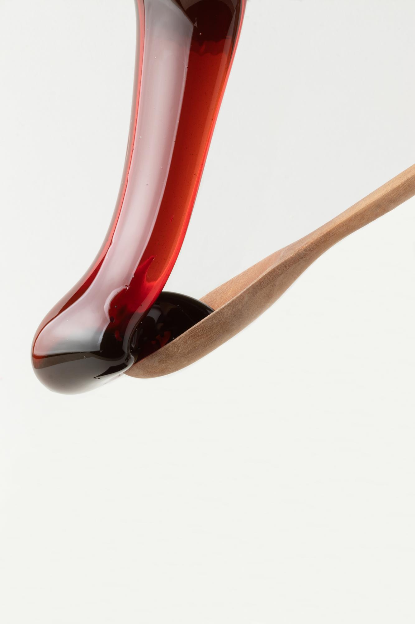 Close-up spoon tasting vibrant sauce
